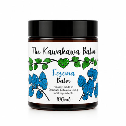 Kawakawa balm jar with white label and black lid on a white background